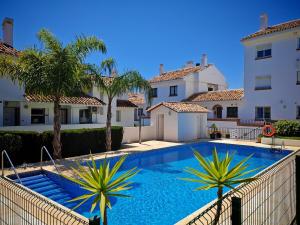 ein Swimmingpool vor einem Haus in der Unterkunft Ground floor near the beach in Málaga