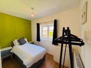 a bedroom with a bed and a window at Welbeck House, close to Swansea Central in Cockett +41 photos