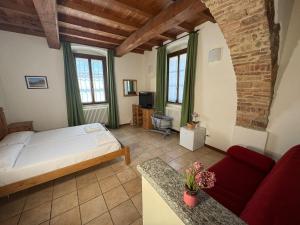 a bedroom with a bed and a couch in a room at Agriturismo Brusignone in Besana in Brianza