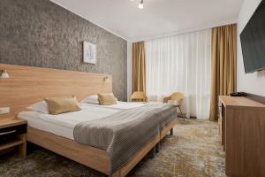 Postel nebo postele na pokoji v ubytování Complex Balnear Cozia - Corp Caciulata