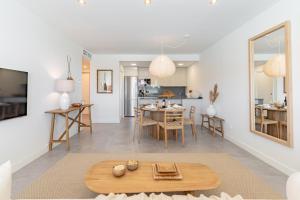 Una sala de estar con una mesa y una cocina. en Casa Cala Serena, en Mijas