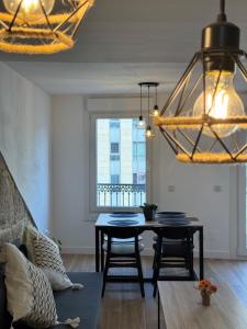 a dining room with a table and a chandelier at CENTRO VIGO Apartamento reformado, AVE-VIALIA - muy céntrico 5PAX in Vigo