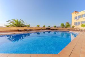 a large swimming pool in front of a building at Penthouse with ocean views - Torviscas in Adeje