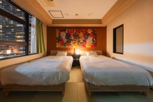 Postel nebo postele na pokoji v ubytování Zen House Umeda