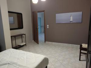 a bedroom with a bed and a room with a lighthouse on the wall at Country treasure in Nea Michaniona