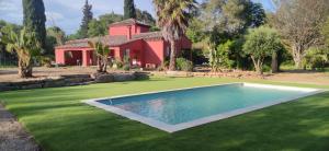 a house with a swimming pool in front of a yard at Villa Katiramona in Le Muy