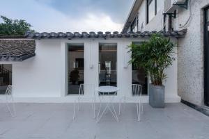 a patio with a table and chairs on it at Suzhou Liuxiang Hotel in Suzhou