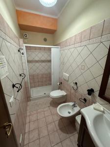 a bathroom with a toilet and a sink and a shower at Residenza Eolo in Tropea