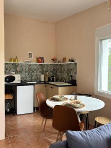 a kitchen with a table and a white table and chairs at Casa Carla Andalucia, el Torcal in Almogía +70 photos