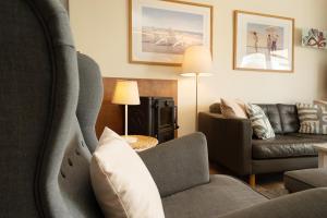 a living room with a couch and a chair at Ferienhaus Brasch in Grömitz