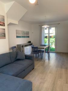a living room with a couch and a table at Appartamento Oberdan in Milano Marittima +7 photos