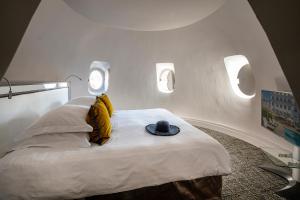 Un ou plusieurs lits dans un hébergement de l'établissement Hôtel Le Canberra