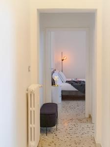 a room with a bedroom with a chair and a bed at Interno 7 in Siena +20 photos