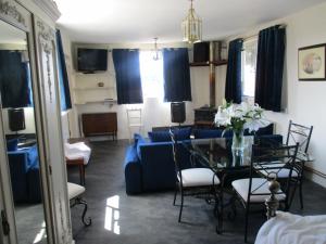 a living room with a blue couch and a glass table at Riverside Lodge At Bridge Stores in Great Yarmouth