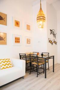 a dining room with a table and a couch at Home Sweet Praia in Nazaré