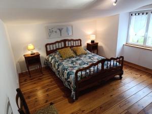 a bedroom with a large bed and two night stands at Gîtes de la Bibudière in Le Boupère