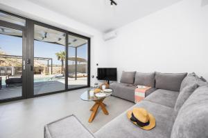 a living room with a couch and a table at Villa 13 Zendo in Kolymbia