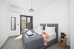 a bedroom with two beds and a table with a lamp at Villa 13 Zendo in Kolymbia +16 photos