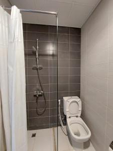 a bathroom with a shower and a toilet at Damac Hills 2- Relaxing 3BR townhouse - Homeyvillas in Dubai