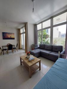 a living room with a couch and a table at Damac Hills 2- Relaxing 3BR townhouse - Homeyvillas in Dubai