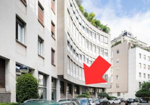 a red arrow on the side of a building at Casa Visconti Milano in Milan