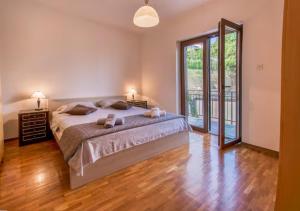 a bedroom with a bed and a large window at Apartments Elza in Portorož