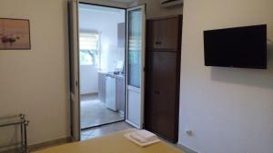 a kitchen with a sliding glass door leading into a kitchen at Apartmani Luka in Herceg-Novi +24 photos
