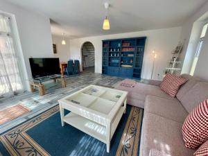 a living room with a couch and a tv at Holiday Rügen Putbus in Putbus