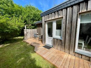 a wooden deck next to a house with a door at Holiday Rügen Putbus in Putbus
