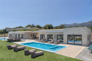 a villa with a swimming pool and a resort at Villa Lux Solis - With 2 Pools in Khoumérion