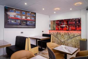 a restaurant with two tables and a bar at Empire Inn in Blackpool