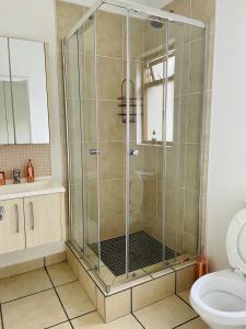 a shower stall in a bathroom with a toilet at 361 On Sunset in Sandton