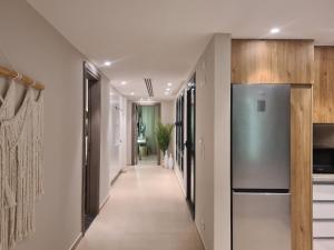 a hallway leading to a kitchen with a refrigerator at El Gouna - 3 Bedroom - Rooftop-Pool - Ancient Hill in Hurghada