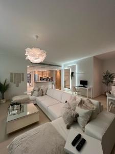 a living room with a white couch and a table at El Gouna - 3 Bedroom - Rooftop-Pool - Ancient Hill in Hurghada
