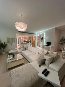 a living room with a white couch and a table at El Gouna - 3 Bedroom - Rooftop-Pool - Ancient Hill in Hurghada +96 photos