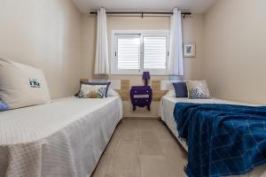 Postel nebo postele na pokoji v ubytování Homes&Go Bell Racó Deluxe III