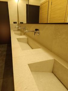 a row of sinks in a public bathroom at AQ miniHOTEL in Shymkent +27 photos