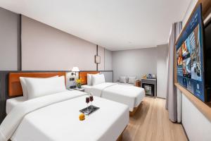 Dingshe Hotel Guangzhou Shamian Island Yongqingfang Branchにあるベッド