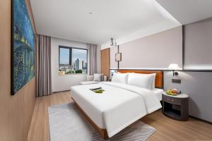 Dingshe Hotel Guangzhou Shamian Island Yongqingfang Branchにあるベッド