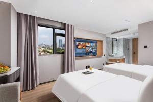 Dingshe Hotel Guangzhou Shamian Island Yongqingfang Branchにあるベッド