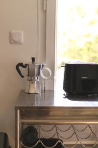 a coffee maker and a microwave on a table at GC - Les Pélicans in Wissant +24 photos