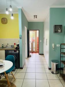 a kitchen with blue and green walls and a table at 361 On Sunset in Sandton +13 photos