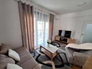 a living room with a couch and a table at Apartman IGOR Trebinje in Trebinje