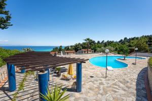 a view of a swimming pool with a wooden deck at Amazing view elegant Maisonette in Kriopigi