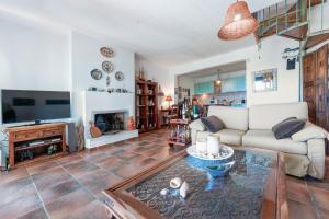 a living room with a couch and a fireplace at Amazing view elegant Maisonette in Kriopigi