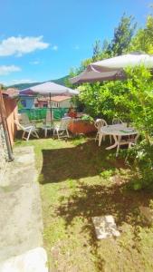 a patio with a table and chairs and an umbrella at Dimora toscana in Santa Maria del Giudice +2 photos