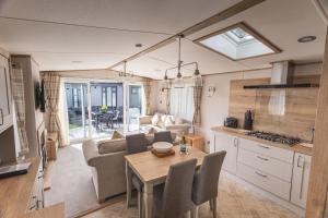 a kitchen and living room with a table and a couch at The Jetty in Christchurch