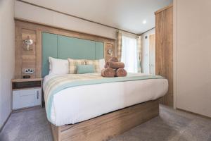 a bedroom with a large bed with two teddy bears on it at The Jetty in Christchurch +31 photos