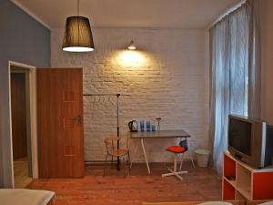 a living room with a table and a television at Kaktus Guest House in Katowice
