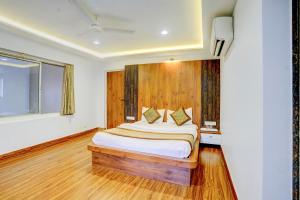 a bedroom with a bed with a wooden headboard at The Byke Heritage - Pan India Pure Veg Hotel Chain in Matheran +72 photos